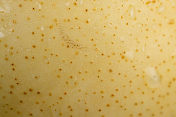 ripe white pear with a yellow colour on the table
