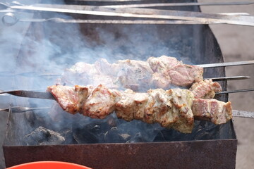 man tries to cook shashlik product on fire shish kebab on the grill