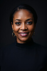 Cheerful black businesswoman from Canada. Profile picture of a friendly African Canadian business lady wearing formal black dress in studio