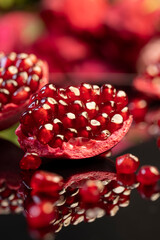 large ripe pomegranate seeds on the table