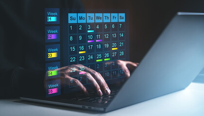 Digital calendar projection over laptop keyboard.