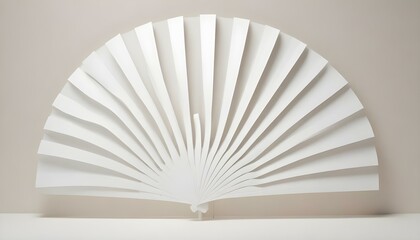 A minimalist abstract art piece features a series of white, blade-like structures arranged in a semi-circular fan shape, set against a soft, light background