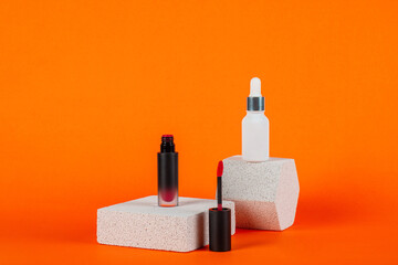 Mockup of black blank thin tube - mascara, lip gloss, gel, eyeliner, oil, etc. Cosmetic package with stylish props on orange background.