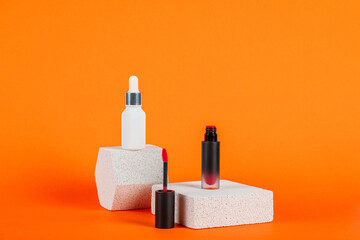 Mockup of black blank thin tube - mascara, lip gloss, gel, eyeliner, oil, etc. Cosmetic package with stylish props on orange background.