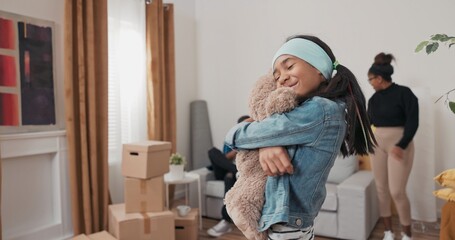 A little girl helps her parents unpack boxes. She discovers her favorite toy, a teddy bear, and...