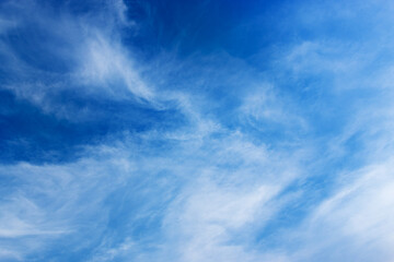 Obraz premium Bright blue sky with soft white clouds background