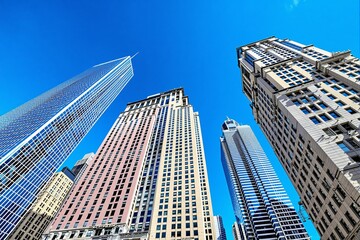 Obraz premium Tall modern skyscrapers seen from street level with strong perspective, digital style, blue sky background, concept of urban growth and architecture. Ai generative