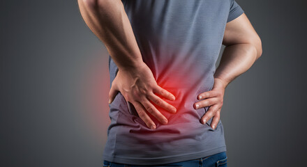 Man suffering from lower back pain, red highlight on affected area