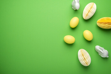 Happy Easter holiday background. Easter decor, eggs and bunny on light green background top view.