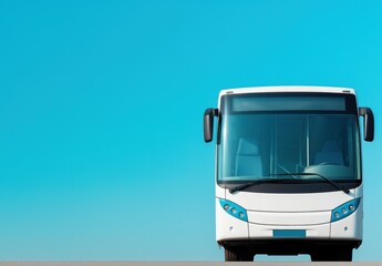 Front view of a modern white bus against a clear blue sky