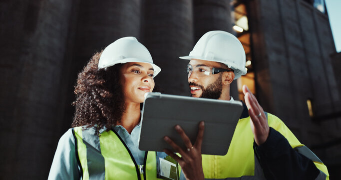 Man, woman and engineer on tablet in city, smile or planning for urban expansion at construction site. People, architect and touchscreen at night, team and app for infrastructure inspection in Brazil