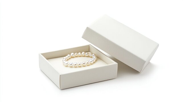 Classic white open jewelry gift box with a pearl necklace inside, isolated against white.