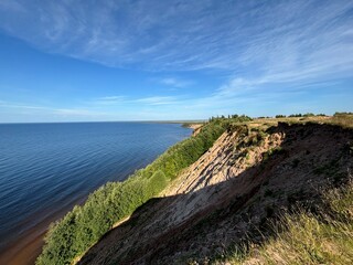 Dangerous mountain cliff into a large body of water in a national park in summer