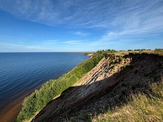 Dangerous mountain cliff into a large body of water in a national park in summer