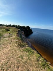 Dangerous mountain cliff into a large body of water in a national park in summer