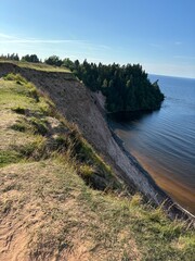steep and gentle shore on the shore of the reservoir in summer
