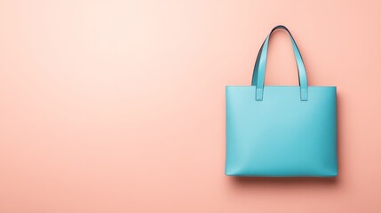 Turquoise tote bag with handles on a peach colored background