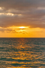 orange sunset is reflected in the blue sea of thailand