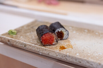 Carefully prepared pair of hosomaki rolls featuring fresh tuna and dried calabash wrapped in crisp...