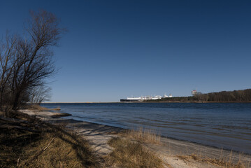 LNG TERMINAL AND GAS TANKER - A black ship moored at the port quay
