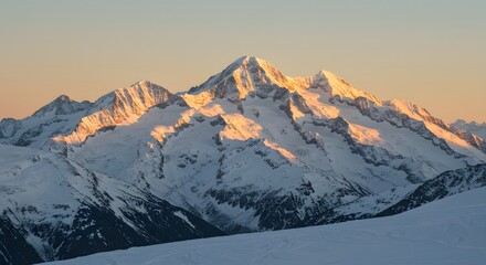 Snowy Mountain Peak at Sunrise with Golden Light and Blue Sky