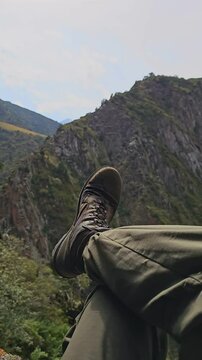 leg in military ankle boot and green pants resting in cross-legged figure four position