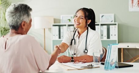Handshake, medical or senior care with doctor and patient in hospital office for consulting. Conversation, feedback or healthcare with medicine professional and mature woman shaking hands for welcome © peopleimages.com