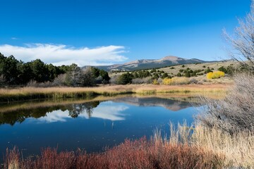 Fototapeta premium Serene mountain lake reflects sky. Autumn colors foreground. Crisp