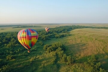 Naklejka premium Colorful Hot Air Balloons Over Lush Green Landscape at Sunrise