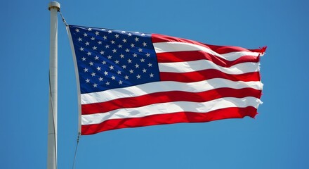 Obraz premium Flag Waving Gently Against a Clear Bright Blue Sky