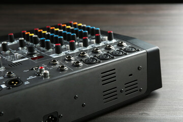 Professional mixing console on wooden table, closeup