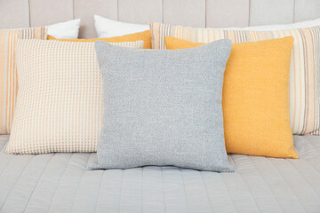 Soft decorative pillows on bed in bedroom