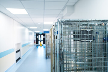 Shallow focus of typical logistic and transport crates which transport supplies for NHS hospitals in the UK. Seen within a hospital corridor after unloading.