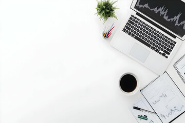 Workspace with laptop showing stock market chart, coffee and plant on white desk top view