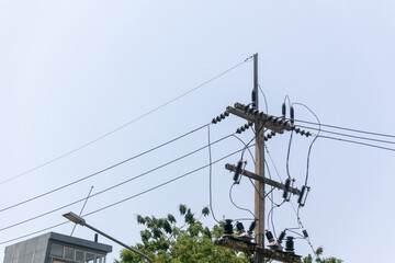 Power Lines and Poles Against Clear Sky in Urban Environment