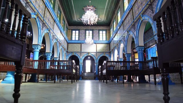 Low angle gimbal footage of historic El Ghriba synagogue in Erriadh, on Djerba island. Religion and architecture in Tunisia.
