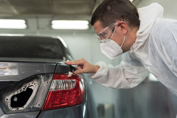Painting car parts concept. Metal part of frame car. Automotive paint services. Quality auto body...