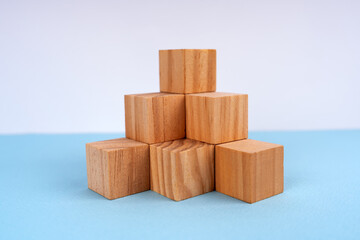 Wooden blocks on pyramid-like model. Business growth concept