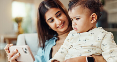 Mom, baby and phone on sofa, happy and care with video, cartoon and streaming in living room. Woman, mother and daughter with smartphone, learning and subscription on couch in lounge at family house