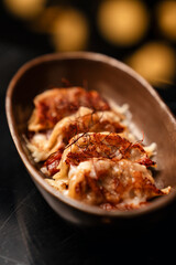 Close-Up of Pan-Fried Gyoza with Spicy Sauce – Japanese Dumplings on Elegant Table Setting