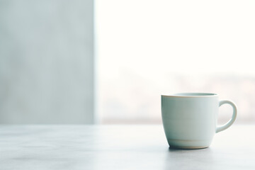 White mug on a marble surface in soft lighting