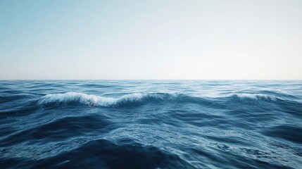 Serene seascape with gentle waves under a soft, light blue sky expanse