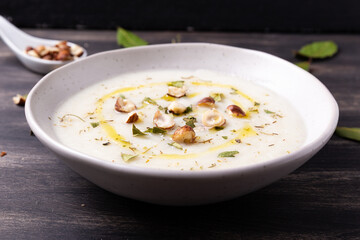 Cauliflower soup with hazelnuts and aromatic herbs. Wnter comfort food and plant based.