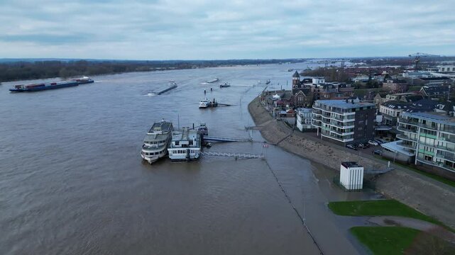 Flying over boats and overflown quay in Tolkamer, a town with an important measuring station for water levels of the Rhine river
