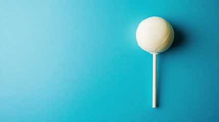 White lollipop candy on blue background sweet treat confectionery dessert food photography flat lay top view