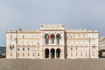 Naklejka premium Trieste, Italy - August 18, 2024: Prefettura di Trieste, a neoclassical building located in Piazza dell'Unità d'Italia, serving as the provincial government headquarters.