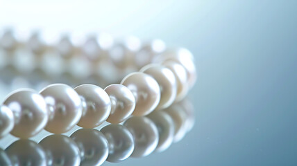 Exquisite pearl necklace arranged on a reflective surface, highlighting its luster.