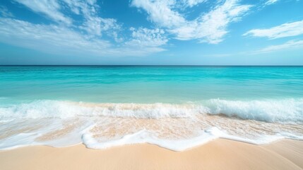 Fototapeta premium Seashore Serenity: A breathtaking view of the ocean with clear, turquoise water gently washing up on a sandy shore under a vast, cloud-filled sky, ideal for travel and relaxation.