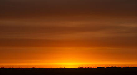 Fiery Horizon: A Dramatic Sunset Display of Orange and Brown Gradient