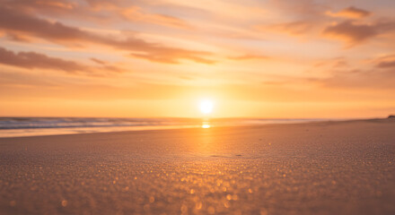 Obraz premium Serene beach sunset bathed in a warm golden hue with peach sky clouds